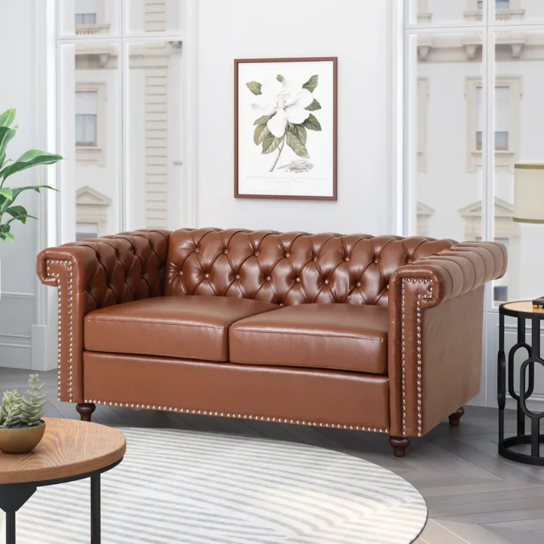 Luxury brown leather Chesterfield sofa set with deep button tufting and rolled arms, crafted by a top sofa set manufacturer for elegant interiors and upscale commercial spaces